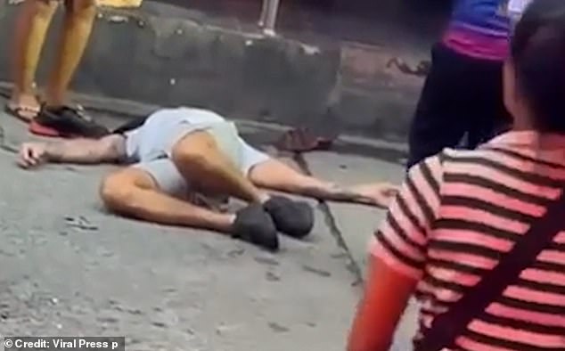 Moments later the man is seen lying motionless on the ground after being hit on the side of the head.