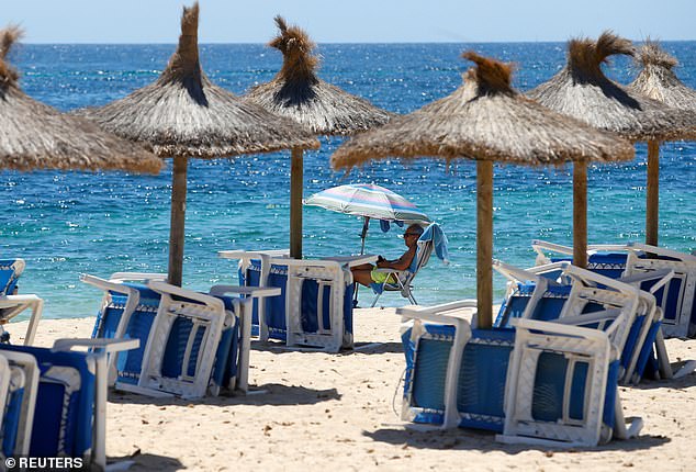 A tourist enjoys time on the beach in Magaluf