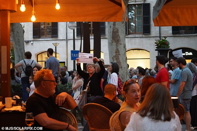 Protesters holding banners with anti-tourism slogans and drumming gathered in the center of the capital, Palma.