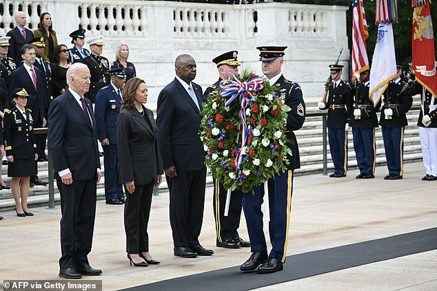 The trio bows their heads as a Marine wears the crown during the ceremony.