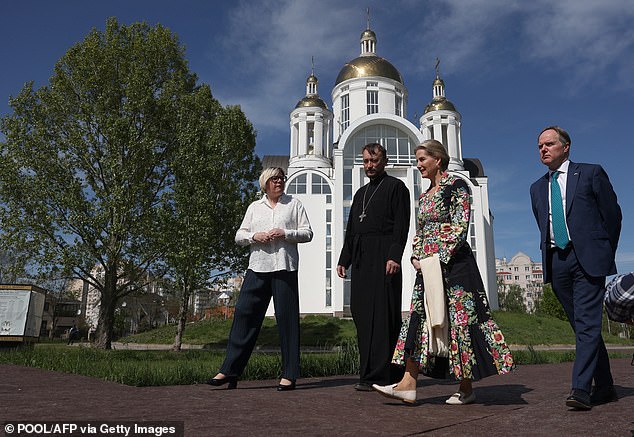 The Duchess of Edinburgh (second right) and the United Kingdom's ambassador to Ukraine, Martin Harris (right), visit the memorial to the victims of the Russian occupation in the town of Bucha on April 29, 2024.