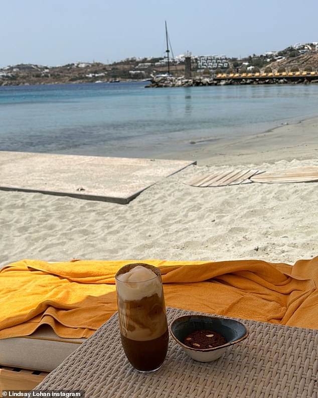 On the beach, Lohan enjoyed a sip of coffee.