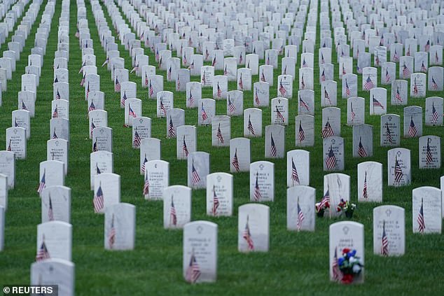 Headstones adorned with American flags are seen at Arlington National Cemetery on Memorial Day in Arlington, Virginia, USA, May 27, 2024.