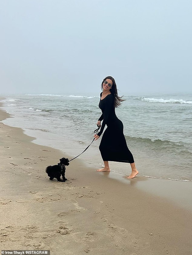 Another photo showed the Vogue cover girl wearing a long black dress while taking her dog for a walk on the beach.