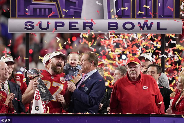 Travis Kelce is seen raising the Lombardi Trophy after the Chiefs won Super Bowl LVIII.