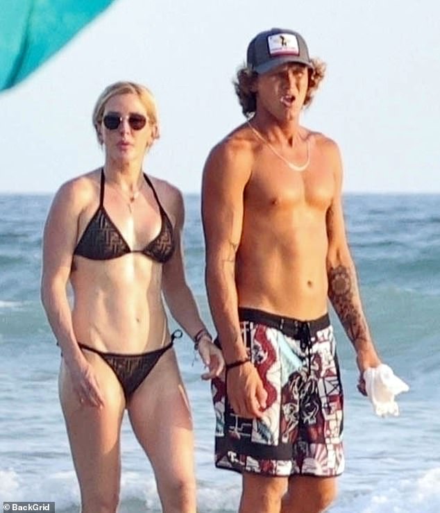 They were then photographed together on the beach in March.