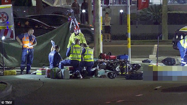 Paramedics try to treat one of the motorists at the scene.