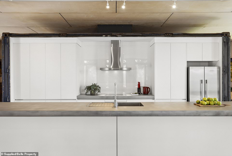 The kitchen is equipped with Miele appliances with sandblasted stainless steel countertops and has underfloor heating.