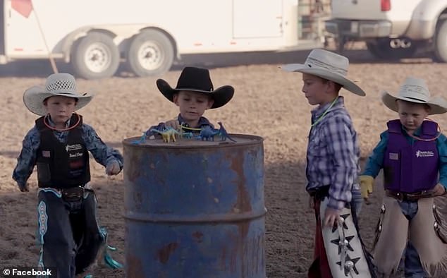 Young cowboys are seen placing a plastic dinosaur in a barrel at the fundraiser for Levi.