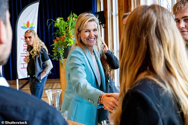 Queen Máxima shakes hands during a visit as part of the MIND Us Leading Locals program at the Wieringerwerf Cultuurschuur