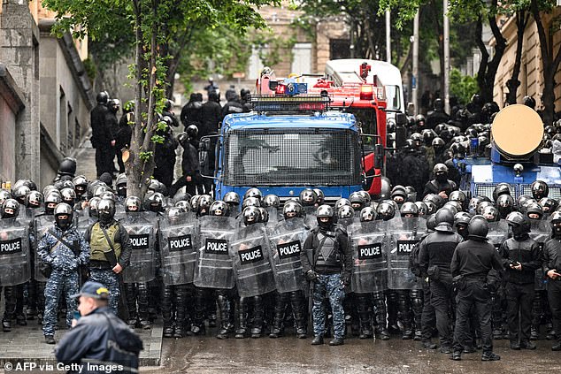 Georgian law enforcement officers are seen deployed on the streets as protesters demonstrate against the controversial "foreign influence" bill in Tbilisi on May 14, 2024