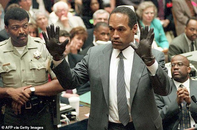 Simpson shows the jury a new pair of oversized Aris gloves, similar to gloves found at a Los Angeles crime scene during his double murder trial, which has inspired controversy.