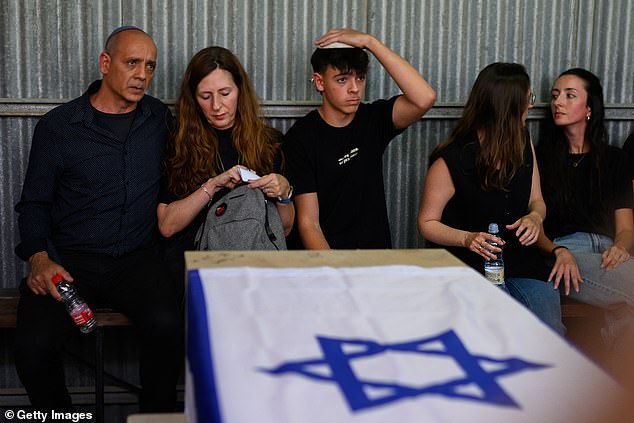 Nissim Louk (L) and Ricarda Louk attend the funeral of their daughter Shani Louk during her funeral on May 19, 2024 in Srigim-Li On, Israel