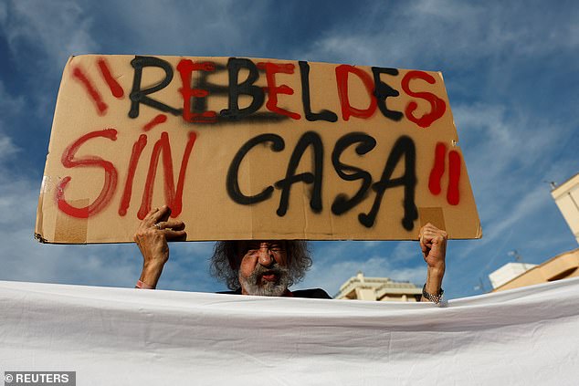 A protester holds a sign that says 