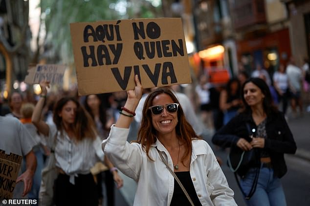 People take part in a protest against mass tourism and gentrification on the island ahead of the summer season in Palma de Mallorca.