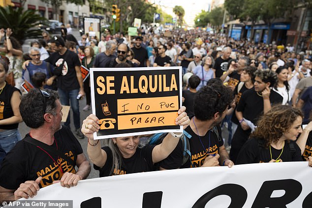 Protesters hold signs that say 