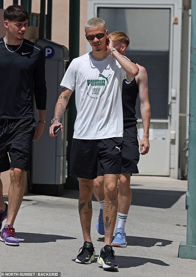 The footballer, 21, was dressed in head-to-toe Puma, accessorising with chic brown tones and silver jewelery as he headed to an Italian lunch at Jon & Vinny's.