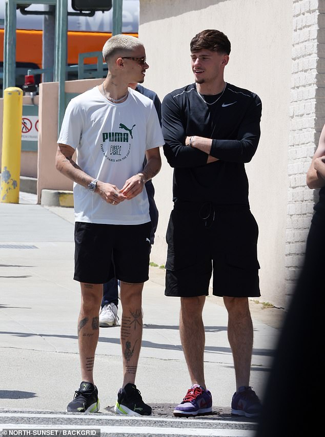 Romeo showed off his tattooed skin in a white t-shirt and shorts.