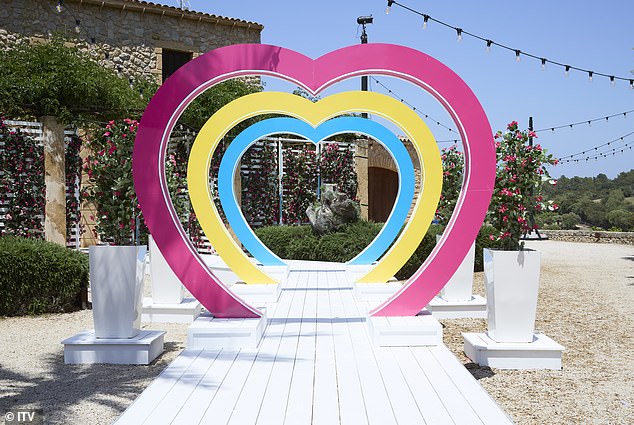 Pink, yellow and blue hearts shape the path towards the villa entrance in sunny Mallorca