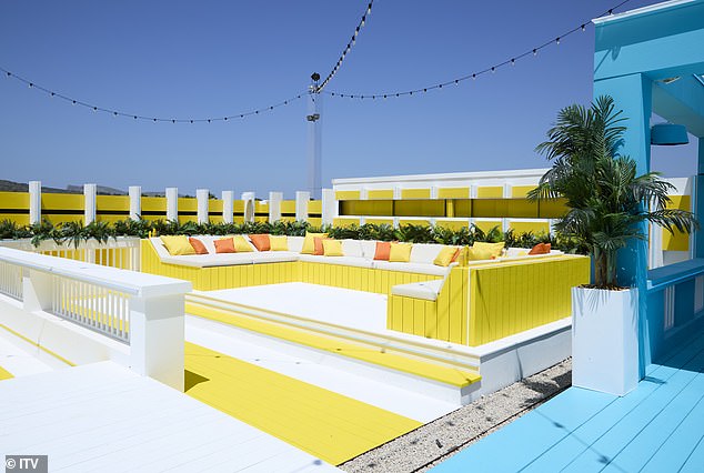 There is a yellow seating area bathed in Spanish sunlight where contestants can meet and tan.