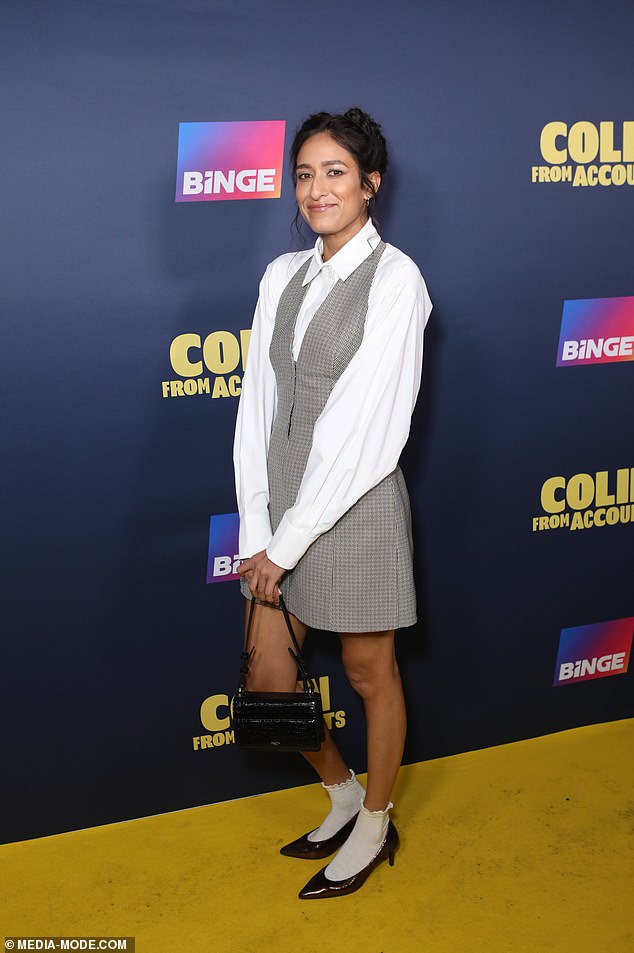 Actress Emma Harvie put on a long-legged display in a halter-neck minidress, which she paired with a white blouse and high-heeled slip-on shoes.