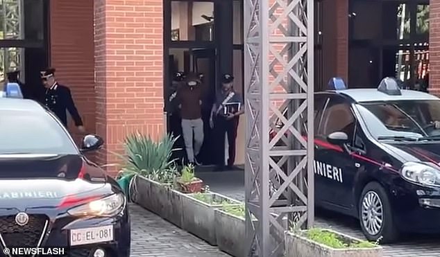 Police officers escort Alessandro Impagnetiello before interrogation