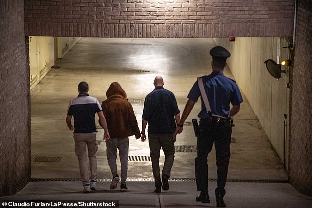 Alessandro Impagnatiello, accompanied by law enforcement, enters the building where Giulia Tramontano's body was hidden.