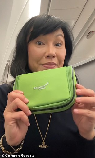 Carmen with the amenity kit, which contained toothpaste, socks, lip balm and more.