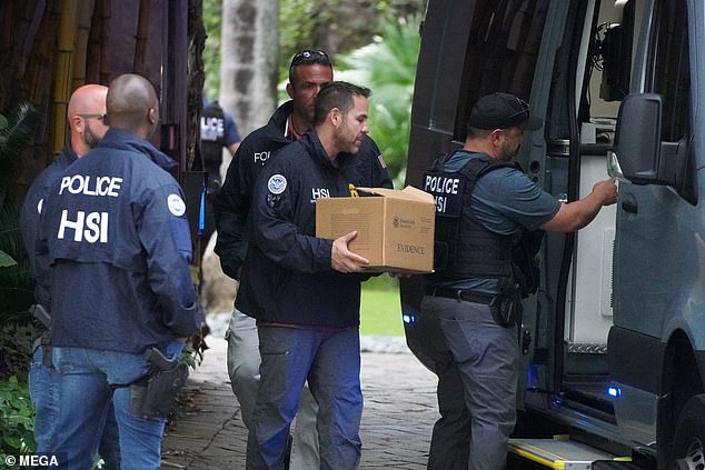 Authorities were removing boxes of evidence and a laptop from Diddy's mansion on Star Island in Miami Beach.