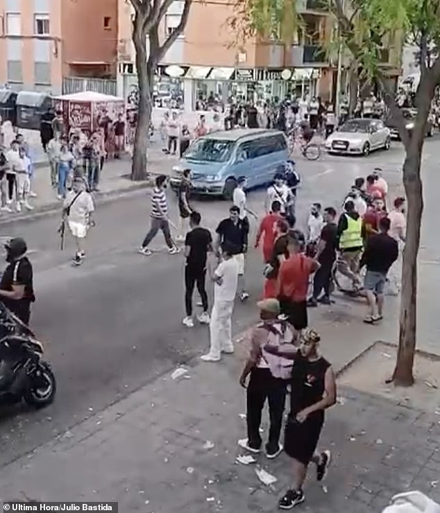 People are seen holding sticks and blunt objects during the street fight that took place on Monday in a neighborhood of Palma after some residents decided to confront an Algerian criminal gang.