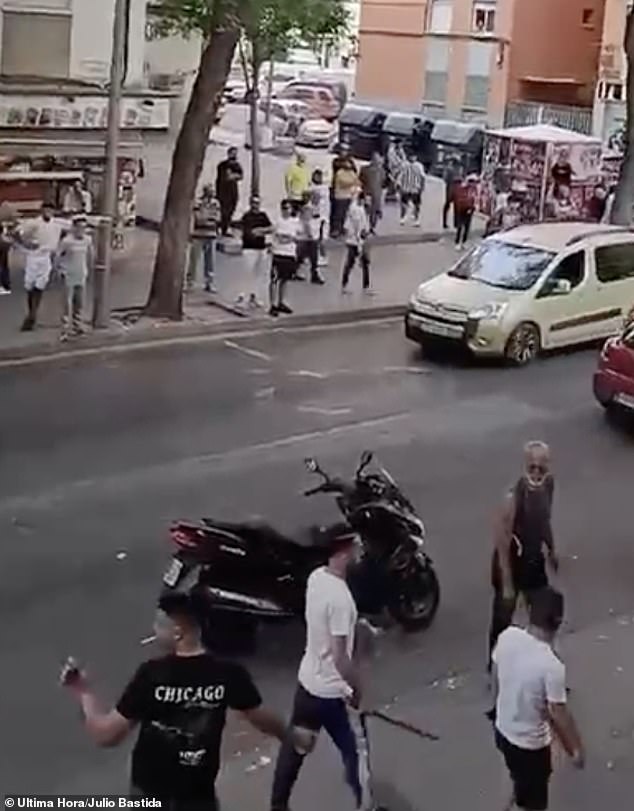 In the photo: A man is seen holding a stick after a fight broke out between residents of a Palma neighborhood and Algerian gang members.