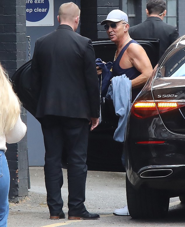 Bruno stripped down to a black gym shirt before greeting onlookers with a smile as he walked through the studio doors.