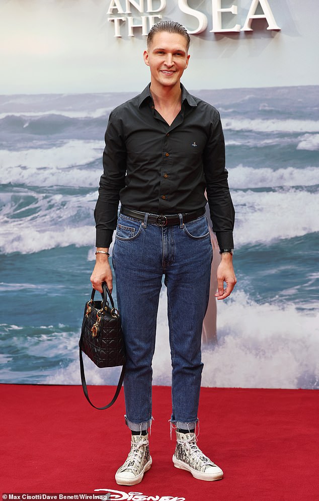 Model Chris Kowalski cut an elegant figure as he arrived on the red carpet while carrying a Dior bag.