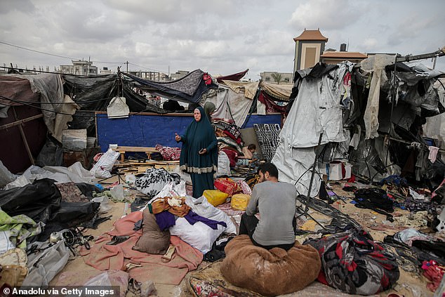 Palestinians cry near makeshift tents after the Israeli bombing of a refugee camp in the al-Mawasi area, west of Rafah.