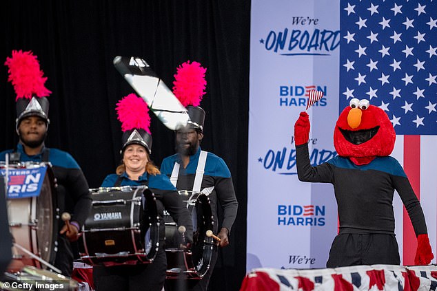 William Fulton, known as 'Philly Elmo,' dances on stage with Positive Movement Entertainment's drum line leader during President Joe Biden and Vice President Kamala Harris' appearance in Philadelphia on Wednesday.