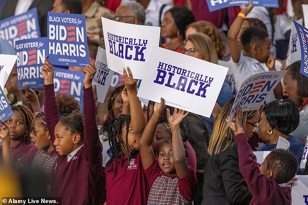 Students at Girard College, a K-12 boarding school that has a predominantly black student body, hold signs that read 