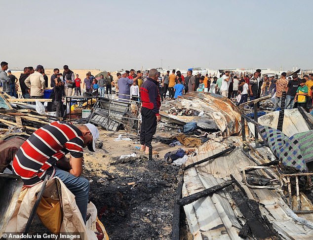 Palestinians surround destruction after Israel bombed their shops and shelters in Rafah on May 27.