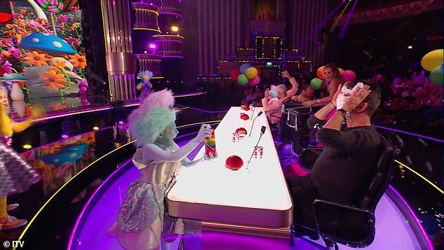 The troll then proceeded to spray Simon with the cream pie filling, much to the delight of the audience and the other judges.