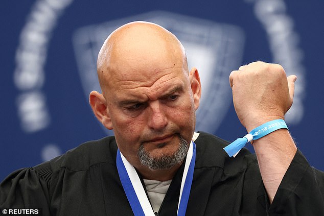 Fetterman (D-PA) shows off a Nova Music Festival bracelet, given to him by a family member of someone taken hostage at the festival.