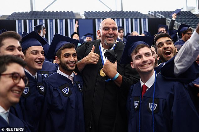 Fetterman poses with Yeshiva graduates who gave him a standing ovation for dropping out of Harvard