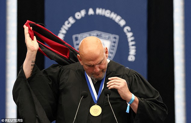 Fetterman (D-PA) removes his Harvard Kennedy School master's graduation hood in protest of Harvard's handling of the Jewish community on campus.