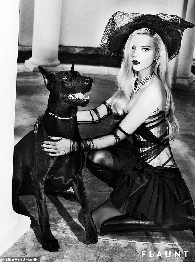 She also paused with a dog while wearing a black corset dress.