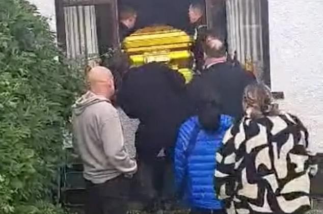 Footage shows the lavish funeral of an Irish gangster who died in a car crash, complete with a golden coffin and topless photographs.