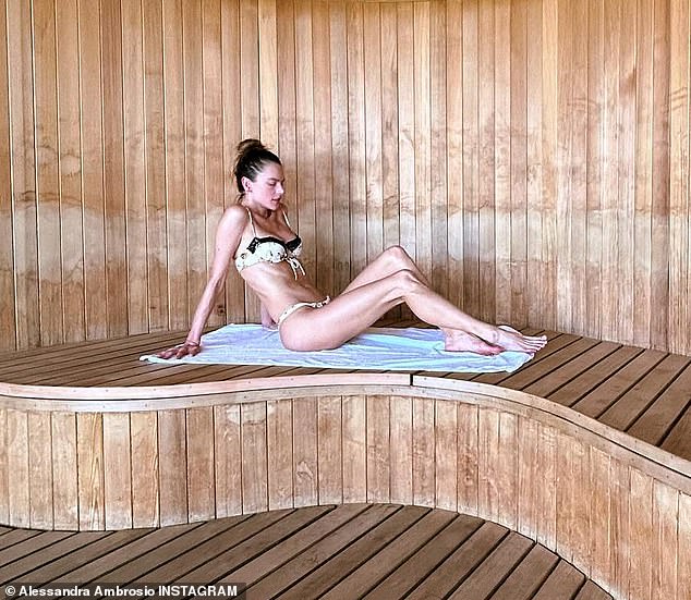 On Instagram, the 43-year-old Brazilian model, who recently stunned in Cannes, wore a tiny white bikini with black lace trim while relaxing in a sauna.