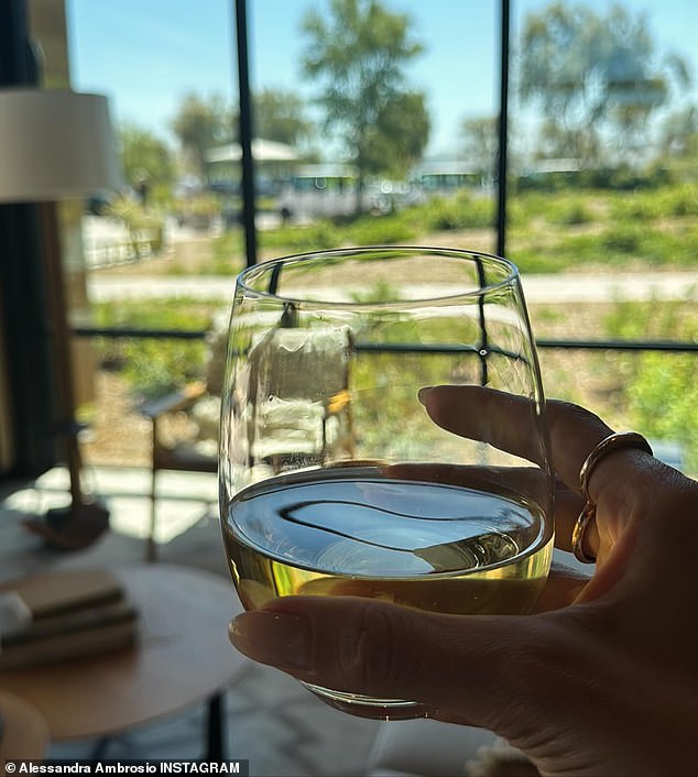 In another snap, we see her holding a glass of white wine while flaunting a pair of gold rings on her fingers.