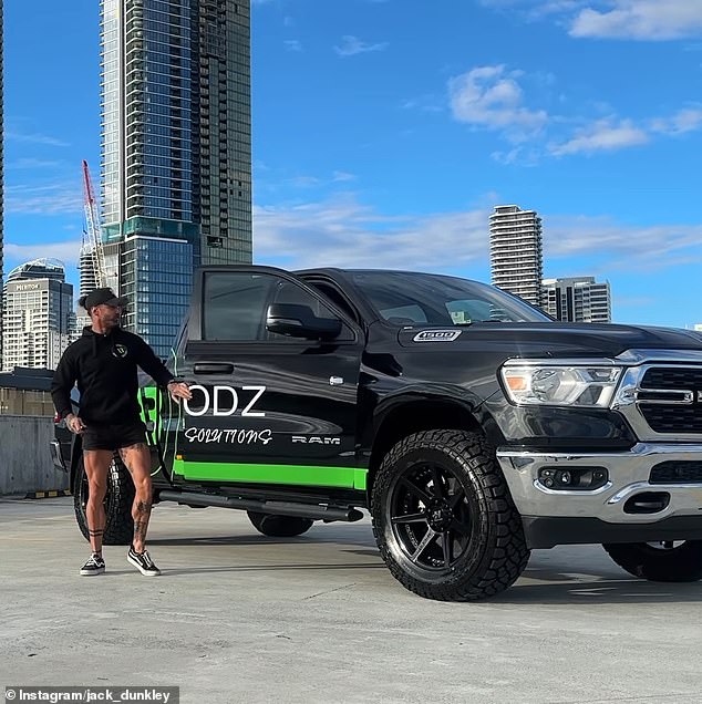 The Gold Coast star was seen smiling as he posed next to a black ute customized with personalized 'ALLBODZ' stickers printed on it.