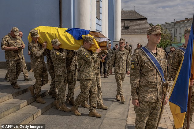 Ukrainian soldiers carry the coffin of the Ukrainian soldier killed in the Donetsk region