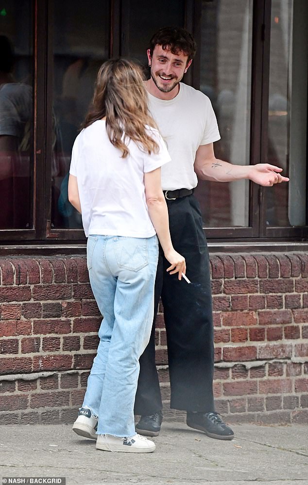 Paul also opted for a low-key look in a white top with black high-waisted pants and Adidas Sambas.