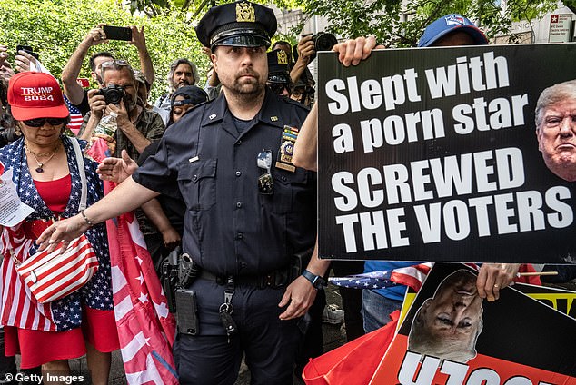 Trump supporters and his opponents argue outside the criminal court where former President Donald Trump is on trial.