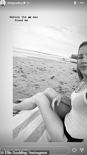 She posed on the beach in a white vest.